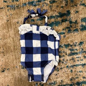 6-12 months. Adorable blue and white checkered bathing suit!